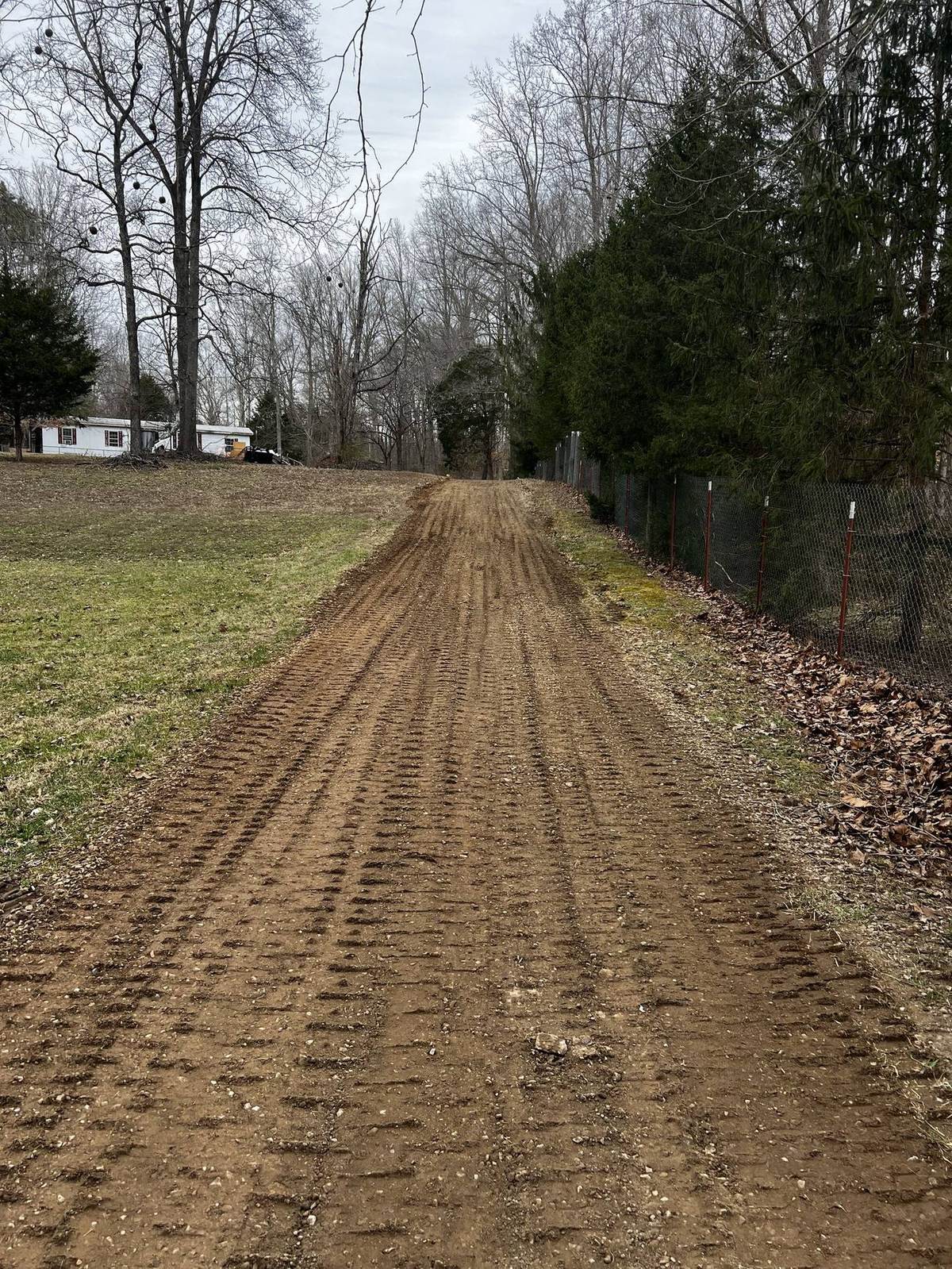 Compacted driveway base graded and ready for gravel